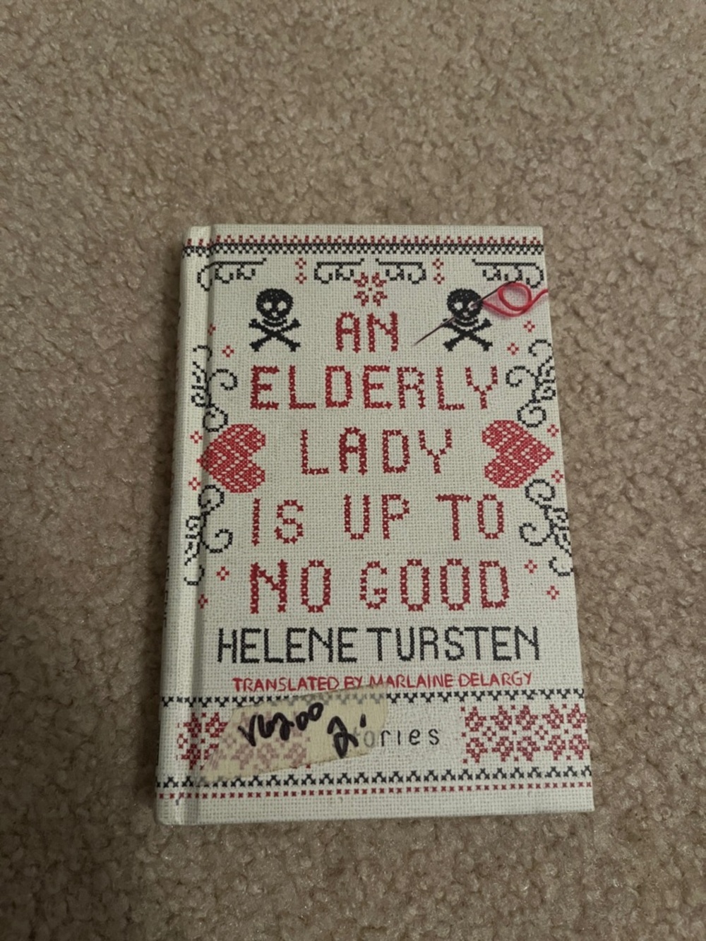 An Elderly Lady Is Up to No Good Hardcover Book - Red/Black Cross-Stitch Cover